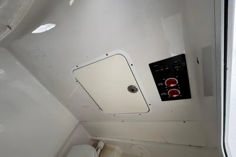  Yacht Photos Pics 2018 Sea Hunt Gamefish 30 interior with control panel and storage compartment.