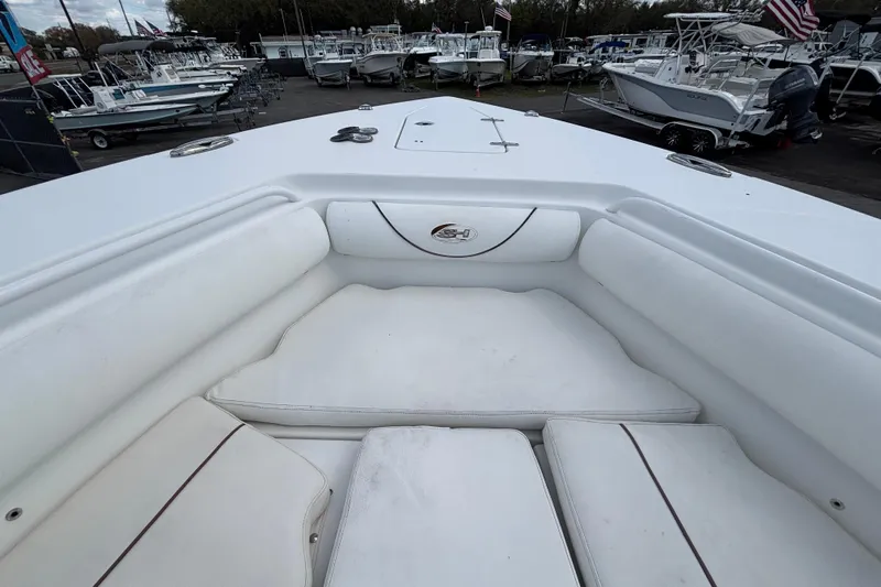  Yacht Photos Pics 2018 Sea Hunt Gamefish 30 Forward Seating, white cushioned bow area, in a boatyard.