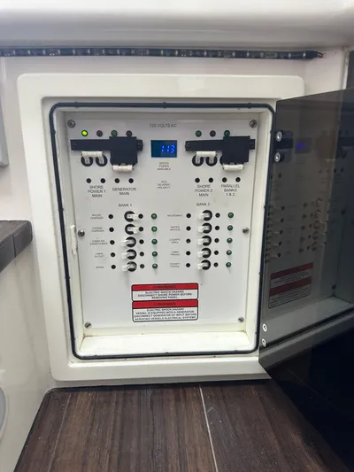 Perfection Yacht Photos Pics Electrical panel on a 2020 Edgewater 370 CC boat, featuring circuit breakers and controls.