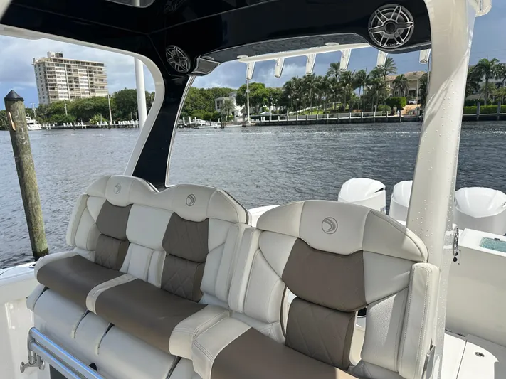 Perfection Yacht Photos Pics Edgewater 370 CC 2020 boat interior with cushioned seating by waterfront.