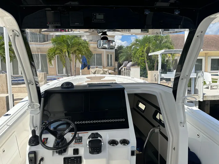 Perfection Yacht Photos Pics Interior view of 2020 Edgewater 370 CC boat cockpit with steering wheel and control panel.