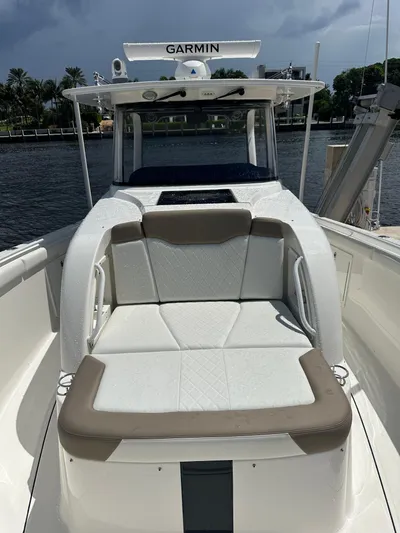 Perfection Yacht Photos Pics 2020 Edgewater 370 CC boat with Garmin equipment, docked by a waterfront.