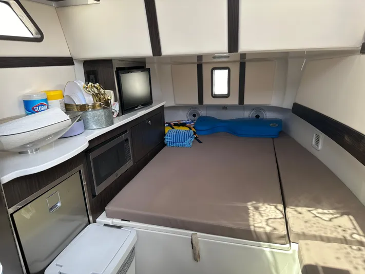 Perfection Yacht Photos Pics Interior cabin of 2020 Edgewater 370 CC boat with bed, microwave, and storage.