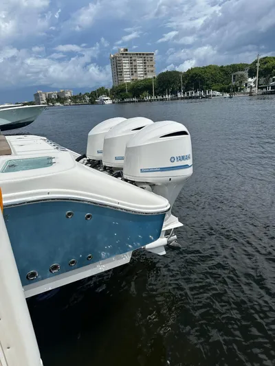 Perfection Yacht Photos Pics 2020 Edgewater 370 CC boat with Yamaha outboard motors docked on a calm waterway.