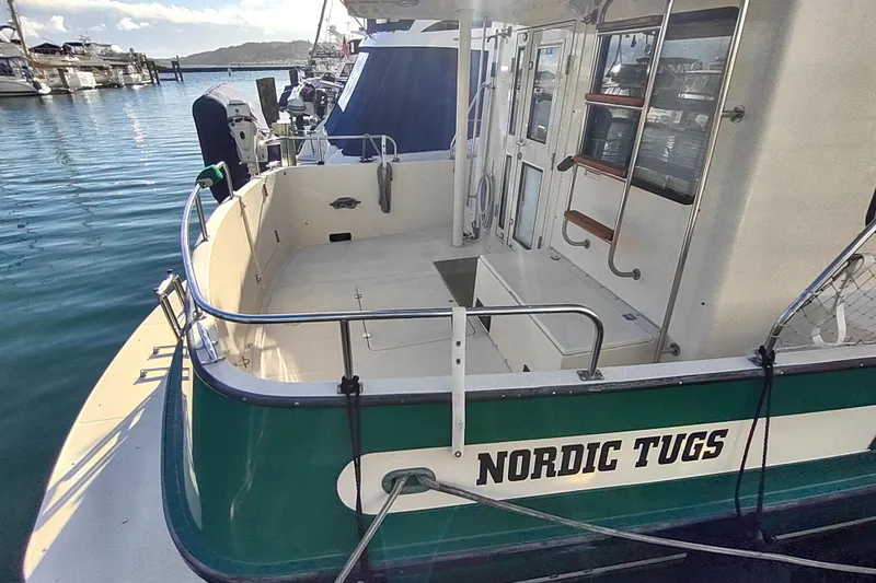 Green Goose Yacht Photos Pics 1998 Nordic Tug 42 docked at marina, showcasing spacious deck and classic design.