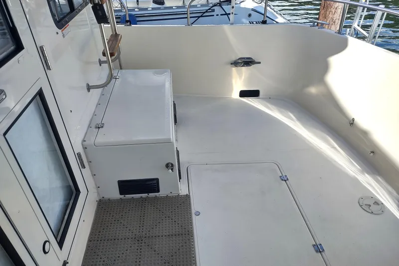 Green Goose Yacht Photos Pics 1998 Nordic Tug 42 boat deck with clean, spacious layout and white finish.