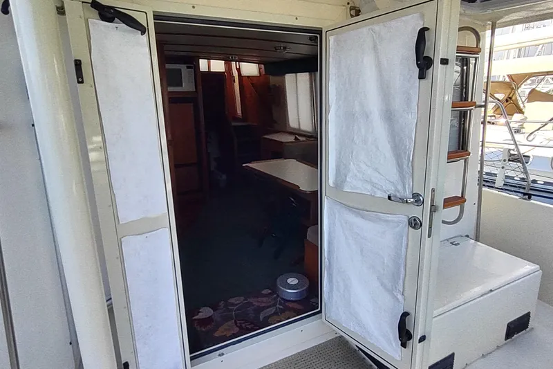 Green Goose Yacht Photos Pics 1998 Nordic Tug 42 interior view with open doors and visible cabin area.