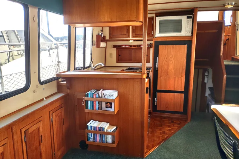 Green Goose Yacht Photos Pics Interior of 1998 Nordic Tug 42 with wooden cabinetry and compact kitchen area.