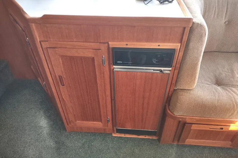 Green Goose Yacht Photos Pics Interior of 1998 Nordic Tug 42 featuring wooden cabinetry and built-in appliance.