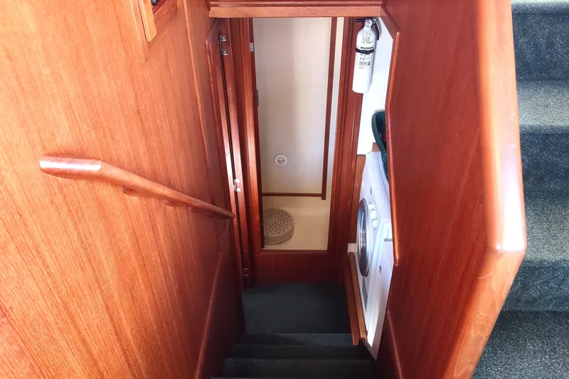 Green Goose Yacht Photos Pics Staircase in 1998 Nordic Tug 42 with wooden handrail and visible washer.