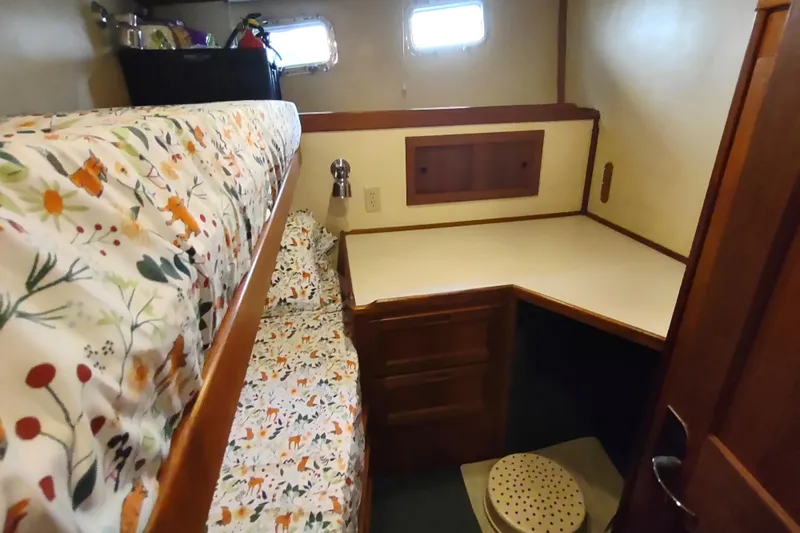 Green Goose Yacht Photos Pics Cozy cabin interior of 1998 Nordic Tug 42 with bunk beds and desk area.