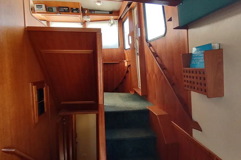 Green Goose Yacht Photos Pics Interior of 1998 Nordic Tug 42 with wooden stairs and nautical decor.