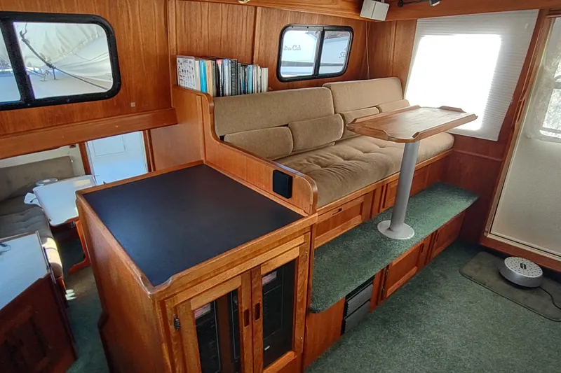 Green Goose Yacht Photos Pics Cozy interior of 1998 Nordic Tug 42 with wood finish and seating area.
