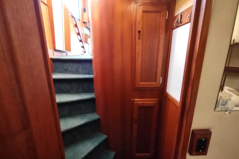 Green Goose Yacht Photos Pics Interior of 1998 Nordic Tug 42 with wooden cabinetry and carpeted stairs.