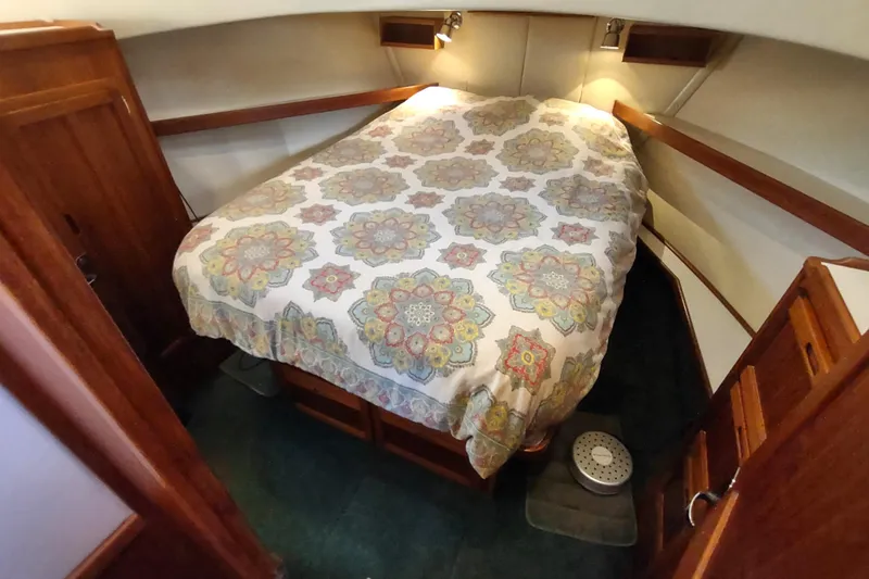 Green Goose Yacht Photos Pics Cozy cabin interior of 1998 Nordic Tug 42 with patterned bedding and wooden furnishings.