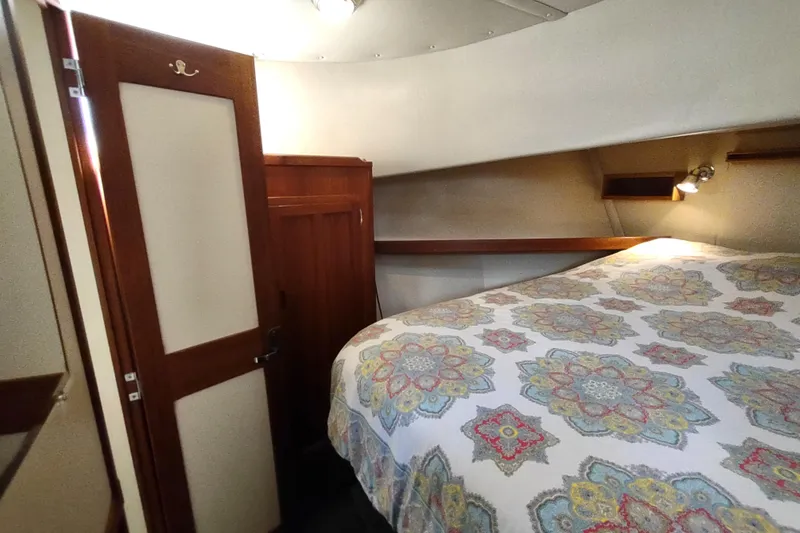 Green Goose Yacht Photos Pics Cozy cabin interior of 1998 Nordic Tug 42 with patterned bedding and wooden accents.