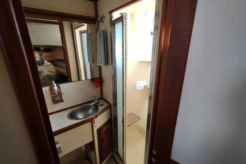Green Goose Yacht Photos Pics 1998 Nordic Tug 42 bathroom with sink, mirror, and shower area.