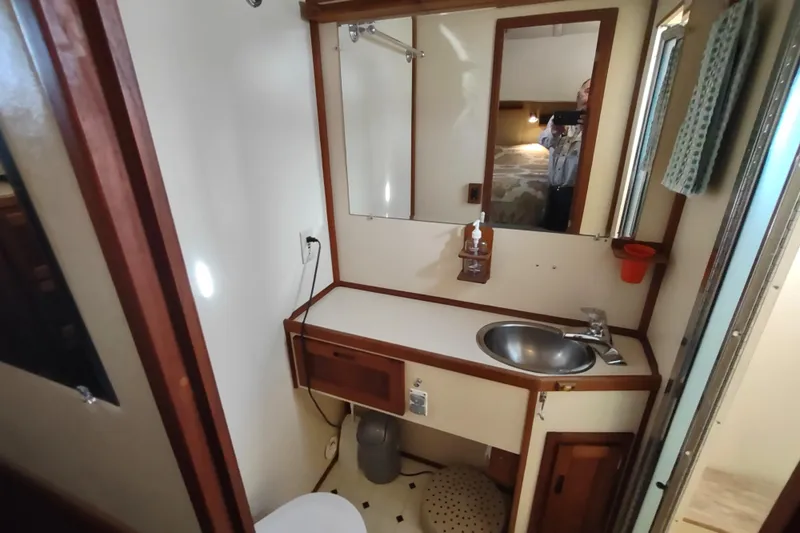 Green Goose Yacht Photos Pics Bathroom interior of a 1998 Nordic Tug 42, featuring a sink and mirror.