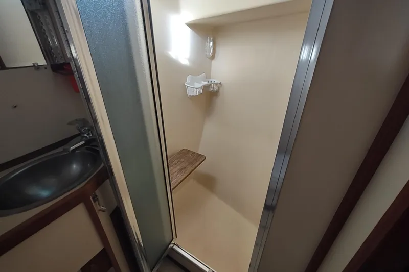 Green Goose Yacht Photos Pics Shower area in 1998 Nordic Tug 42 boat with wooden seat and stainless steel sink.