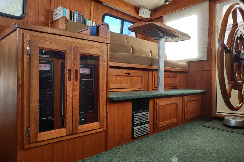 Green Goose Yacht Photos Pics Interior of 1998 Nordic Tug 42, featuring wooden cabinetry and helm station.
