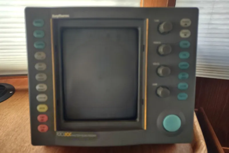 Green Goose Yacht Photos Pics 1998 Nordic Tug 42 navigation system with buttons and display screen.