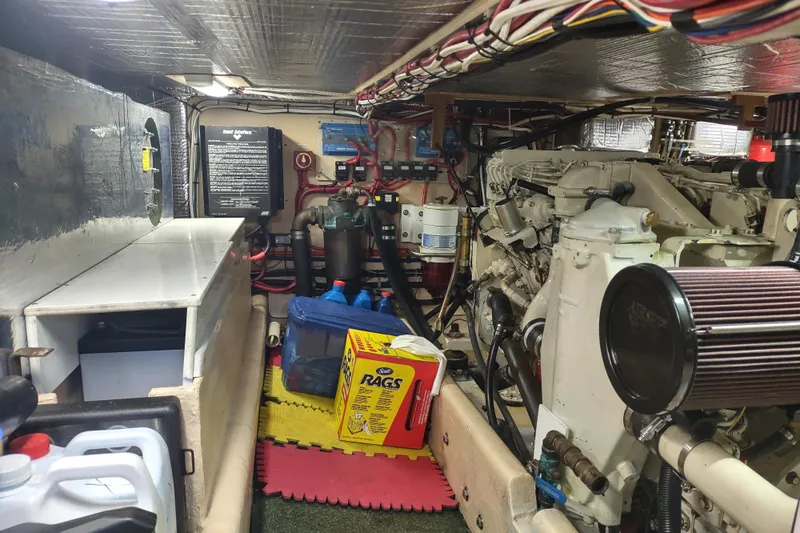 Green Goose Yacht Photos Pics Engine room of a 1998 Nordic Tug 42, featuring machinery and maintenance supplies.