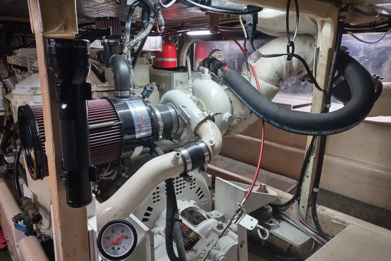 Green Goose Yacht Photos Pics Engine room of a 1998 Nordic Tug 42, showcasing mechanical components and hoses.