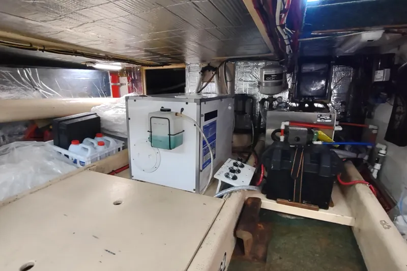 Green Goose Yacht Photos Pics Engine room of a 1998 Nordic Tug 42, featuring equipment and storage.