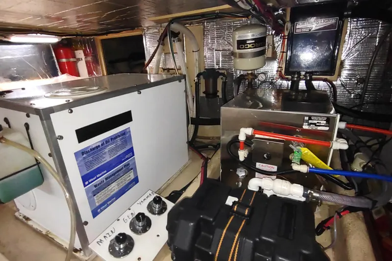 Green Goose Yacht Photos Pics Engine room of a 1998 Nordic Tug 42 with various mechanical components.
