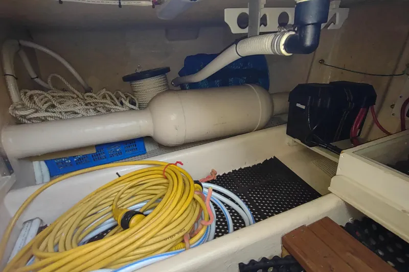Green Goose Yacht Photos Pics Storage compartment of a 1998 Nordic Tug 42 with ropes and cables.