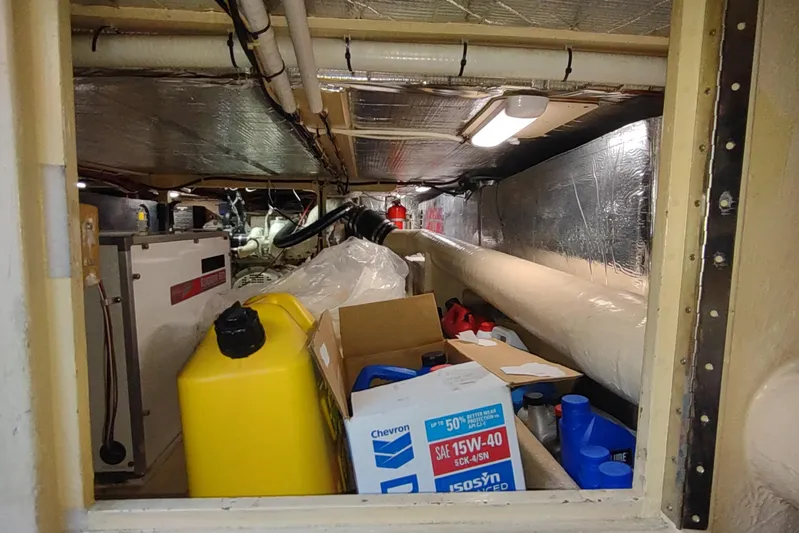 Green Goose Yacht Photos Pics Engine room of 1998 Nordic Tug 42 with storage and maintenance supplies.