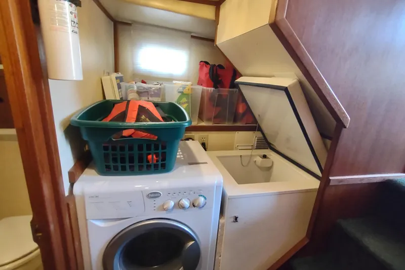 Green Goose Yacht Photos Pics Laundry area on a 1998 Nordic Tug 42 boat with washer and storage.