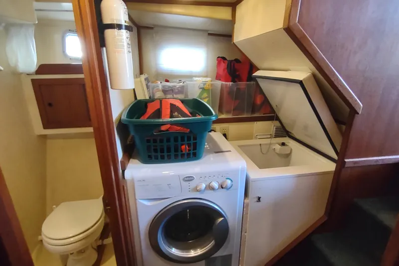 Green Goose Yacht Photos Pics Laundry area on 1998 Nordic Tug 42 with washer, dryer, and storage.