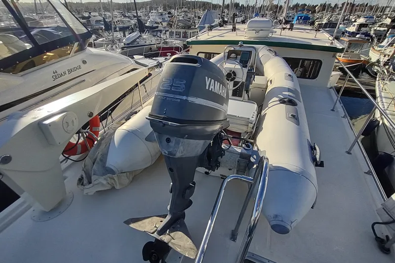 Green Goose Yacht Photos Pics 1998 Nordic Tug 42 with Yamaha outboard motor, docked at a marina.