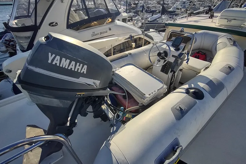 Green Goose Yacht Photos Pics Inflatable boat with Yamaha outboard motor, docked near a Nordic Tug 42, 1998 model.