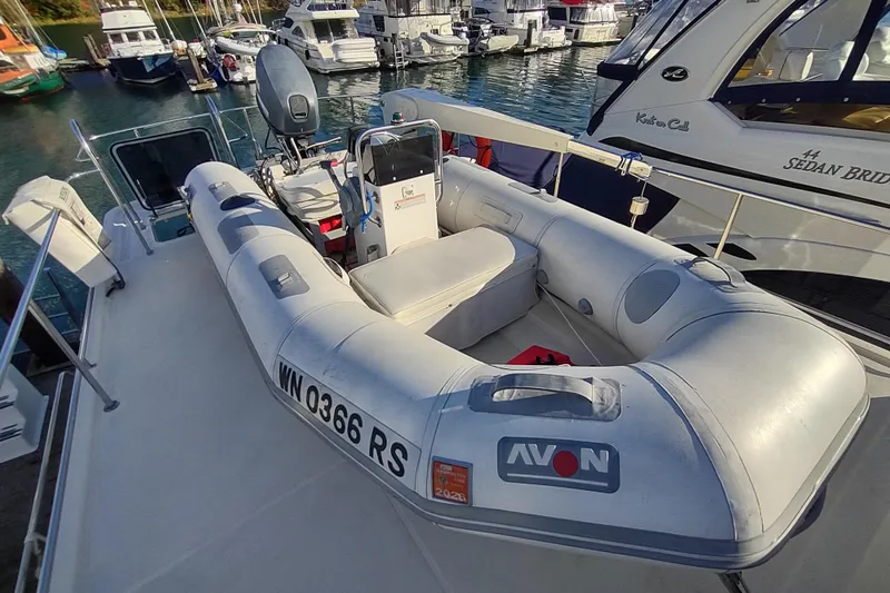 Green Goose Yacht Photos Pics A 1998 Nordic Tug 42 with an Avon inflatable boat docked at a marina.