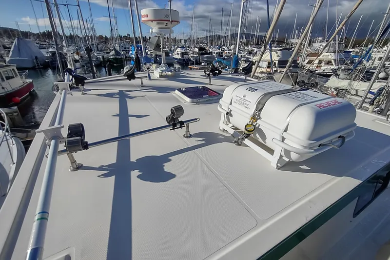 Green Goose Yacht Photos Pics Nordic Tug 42 (1998) deck view with life raft, docked in marina.