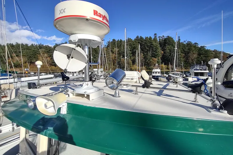 Green Goose Yacht Photos Pics 1998 Nordic Tug 42 with radar equipment, docked in a marina under clear blue skies.
