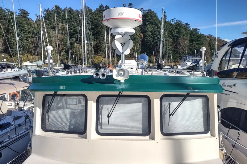 Green Goose Yacht Photos Pics 1998 Nordic Tug 42 at marina, featuring radar and navigation equipment.