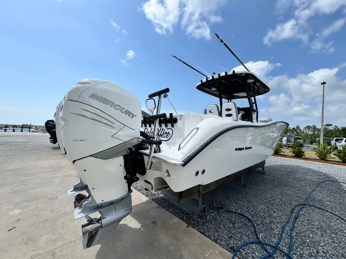 Yacht Photos Pics 2022 Cape Horn 32 T boat with dual Mercury engines, docked under a clear blue sky.