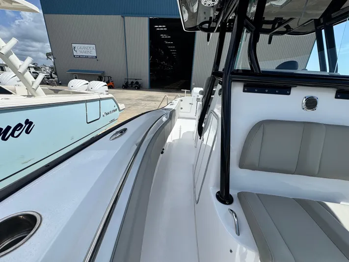  Yacht Photos Pics 2022 Cape Horn 32 T boat, white interior, docked near a large warehouse.