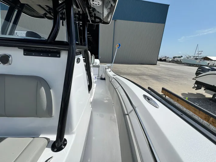  Yacht Photos Pics 2022 Cape Horn 32 T boat, side view, docked near a large warehouse.