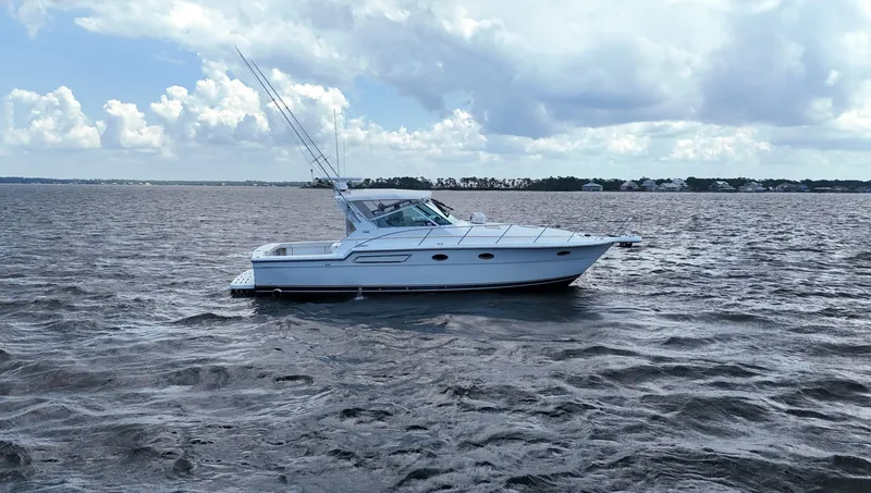 Extremely Clean Boat Yacht Photos Pics 2000 Tiara Yachts 3700 Open cruising on a calm sea under a cloudy sky.