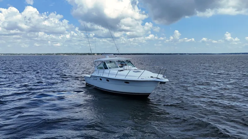 Extremely Clean Boat Yacht Photos Pics 2000 Tiara Yachts 3700 Open cruising on a calm sea under a partly cloudy sky.