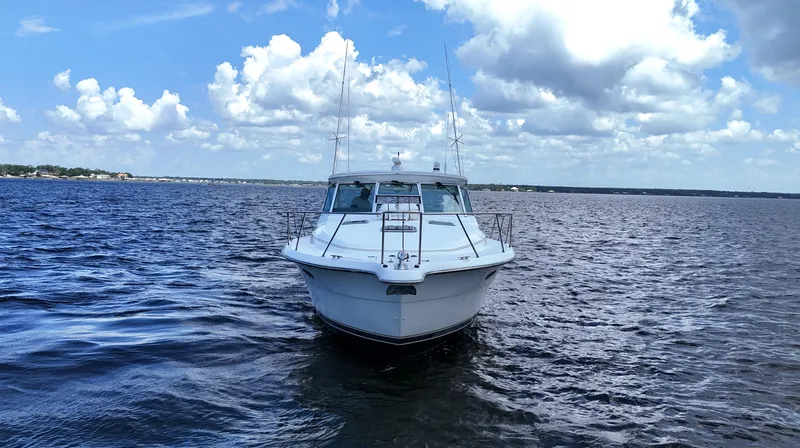 Extremely Clean Boat Yacht Photos Pics 2000 Tiara Yachts 3700 Open on calm water under a partly cloudy sky.
