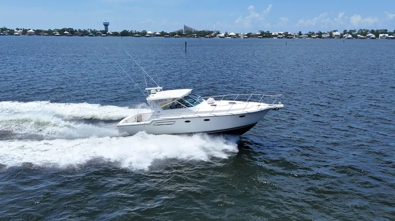 Extremely Clean Boat Yacht Photos Pics 2000 Tiara Yachts 3700 Open cruising on a sunny day, creating waves in the water.