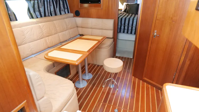 Extremely Clean Boat Yacht Photos Pics Interior of 2000 Tiara Yachts 3700 Open with cozy seating and wooden flooring.