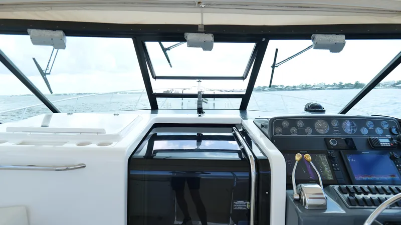 Extremely Clean Boat Yacht Photos Pics Cockpit view of 2000 Tiara Yachts 3700 Open, showcasing controls and ocean horizon.