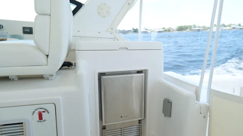 Extremely Clean Boat Yacht Photos Pics 2000 Tiara Yachts 3700 Open interior with seating and fire extinguisher compartment.