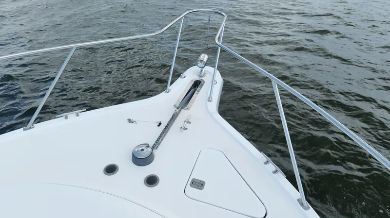 Extremely Clean Boat Yacht Photos Pics Bow of 2000 Tiara Yachts 3700 Open on water, featuring anchor and railing.